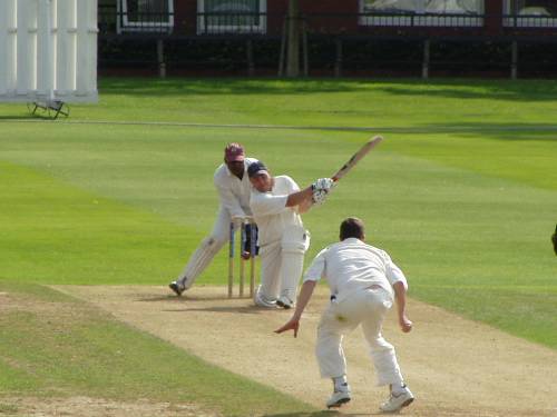 Ev Fox keeping and Andy Owen bowling.